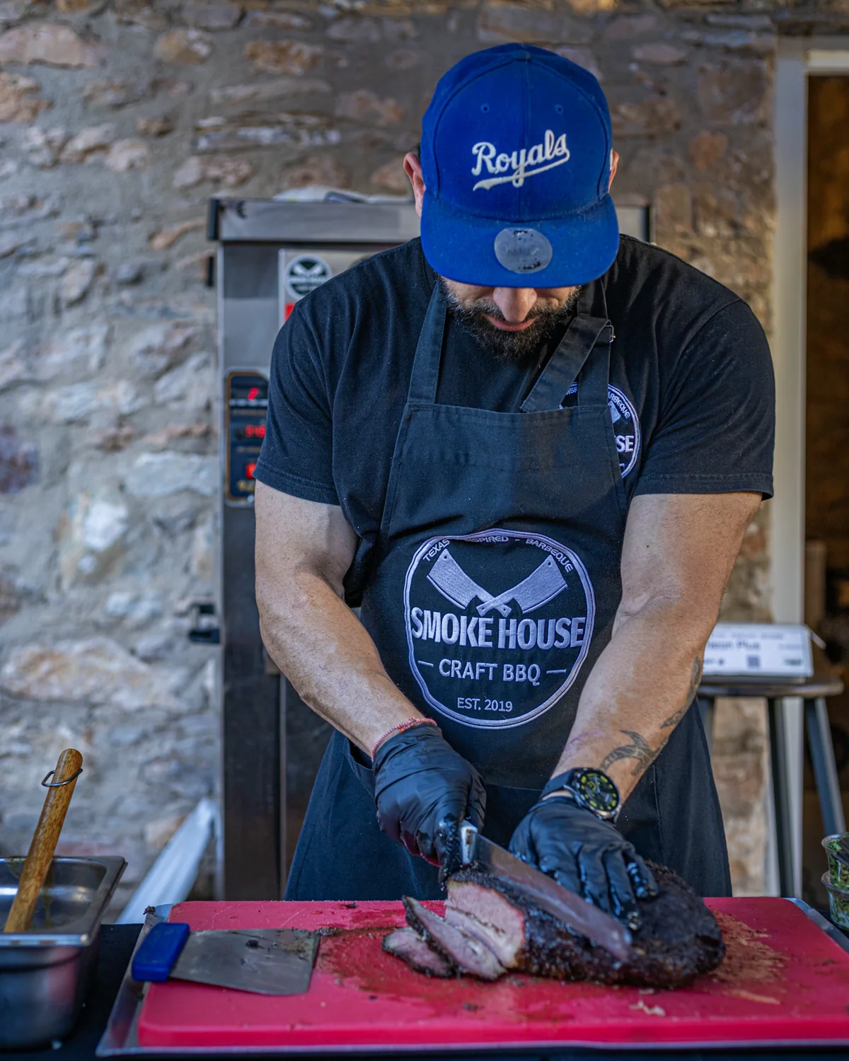 Ο Takis κόβει καπνιστό brisket στο Smoke House.